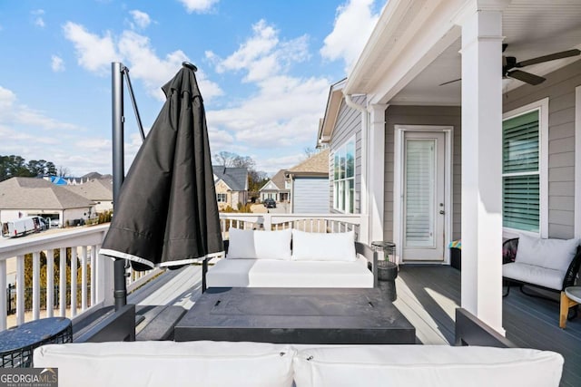 deck featuring an outdoor hangout area, a ceiling fan, and a residential view