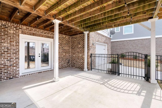view of patio featuring french doors and fence