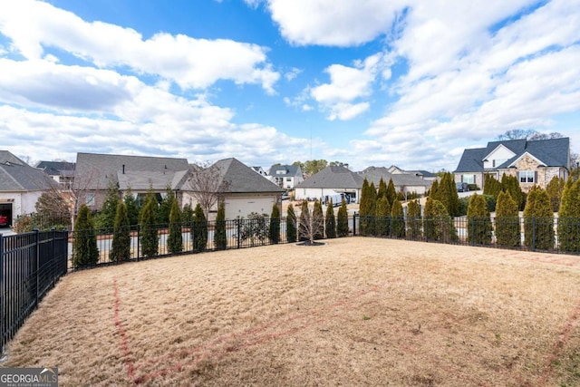 view of property's community featuring a residential view and fence