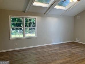 470 Ovara Ct, Stone Mountain, GA 30088 - additional living space with a skylight and dark wood-type flooring