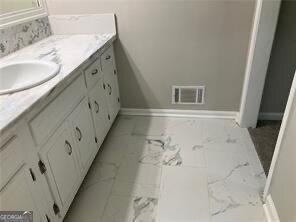 470 Ovara Ct, Stone Mountain, GA 30088 - bathroom with marble finish floors and vanity
