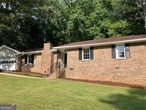 470 Ovara Ct, Stone Mountain, GA 30088 - exterior space with a garage, a chimney, and a front lawn