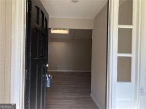 470 Ovara Ct, Stone Mountain, GA 30088 - hall featuring dark wood finished floors and baseboards