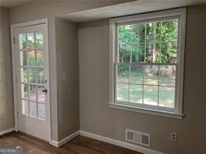 470 Ovara Ct, Stone Mountain, GA 30088 - doorway to outside featuring baseboards, visible vents, and dark wood-style flooring