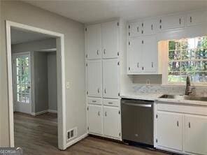 470 Ovara Ct, Stone Mountain, GA 30088 - kitchen featuring stainless steel dishwasher, white cabinets, dark wood-style flooring, and light countertops
