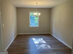 470 Ovara Ct, Stone Mountain, GA 30088 - unfurnished dining area featuring a chandelier, baseboards, and wood finished floors