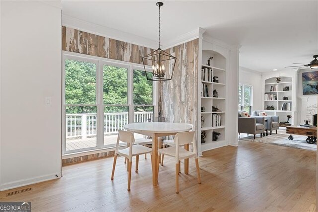 4030 Scenic View Ct, Cumming, GA 30028 - dining area with built in shelves, visible vents, baseboards, wood finished floors, and ceiling fan with notable chandelier