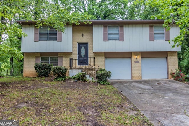 5802 Oakleaf Dr, Stone Mountain, GA 30087 - split foyer home with driveway, brick siding, and an attached garage