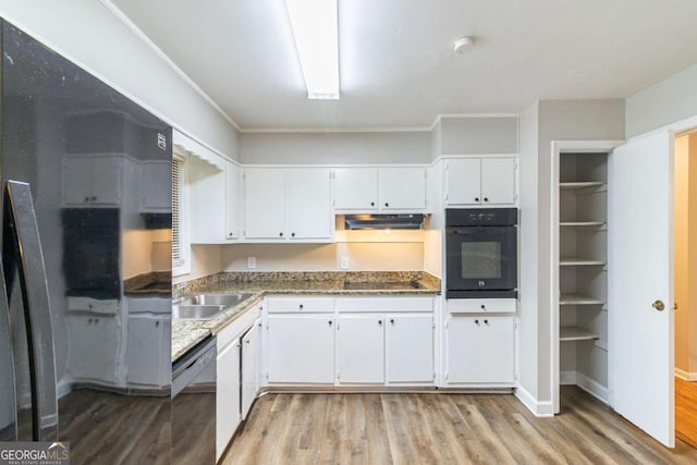 5802 Oakleaf Dr, Stone Mountain, GA 30087 - kitchen with light wood finished floors, a sink, white cabinetry, light stone countertops, and black appliances