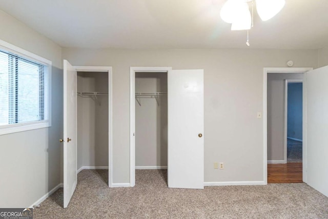 5802 Oakleaf Dr, Stone Mountain, GA 30087 - unfurnished bedroom with baseboards, multiple closets, and light colored carpet