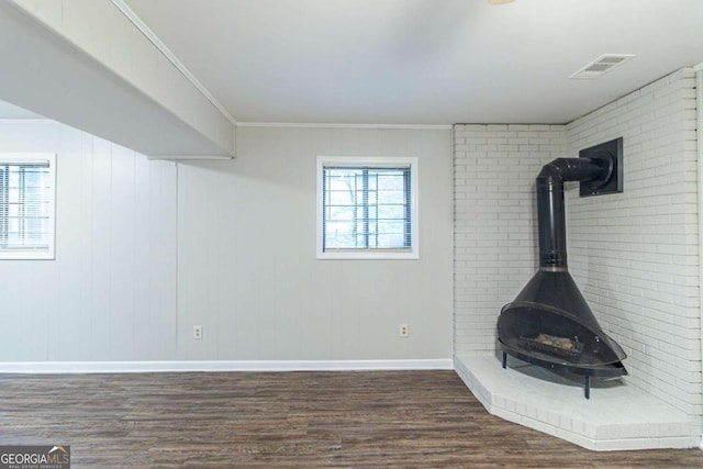 5802 Oakleaf Dr, Stone Mountain, GA 30087 - unfurnished living room featuring dark wood-style flooring, a wood stove, baseboards, and visible vents