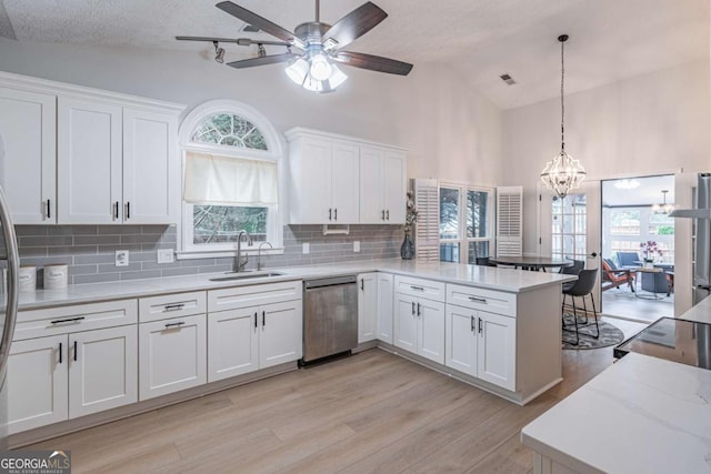 220 Chandler Ct, Sugar Hill, GA 30518 - kitchen featuring dishwasher, a sink, a peninsula, white cabinetry, and a chandelier