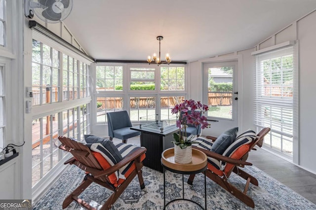 220 Chandler Ct, Sugar Hill, GA 30518 - sunroom with lofted ceiling, plenty of natural light, wood finished floors, and a chandelier