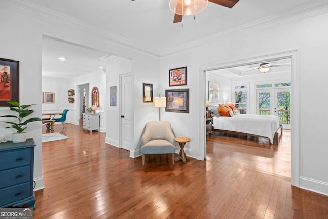 bedroom featuring baseboards, hardwood / wood-style flooring, and crown molding