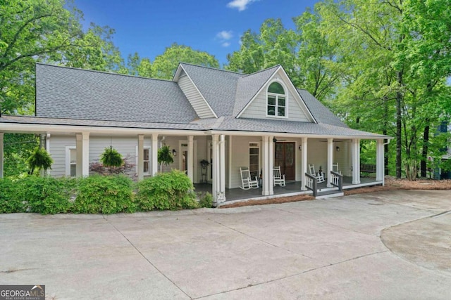 view of front of home with a porch and roof with shingles