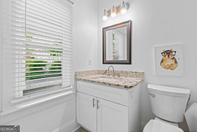 bathroom featuring toilet and vanity