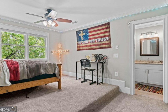 bedroom with ornamental molding, a sink, carpet floors, and visible vents