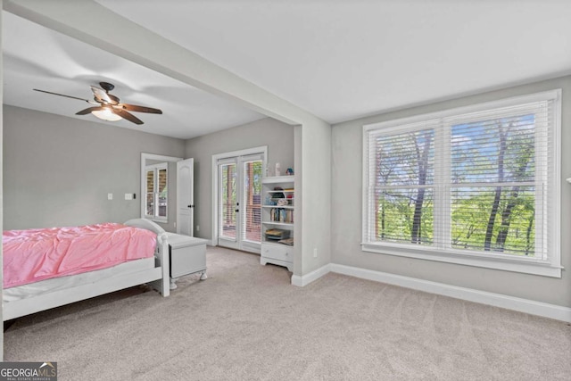 bedroom featuring carpet floors, baseboards, access to exterior, and multiple windows