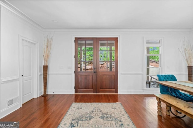 foyer entrance with ornamental molding, visible vents, french doors, and wood finished floors