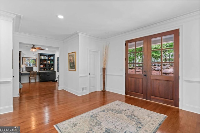 foyer entrance with wood finished floors, french doors, and crown molding