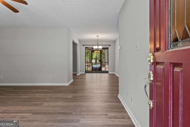 108 Ashwood Pt Unit 196, Eatonton, GA 31024 - entryway featuring dark wood finished floors, ceiling fan, and a chandelier