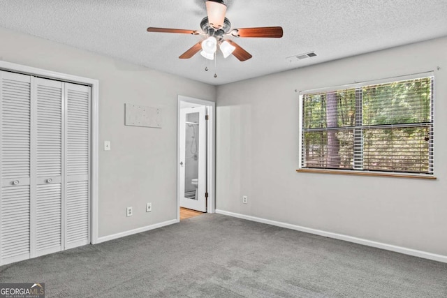 108 Ashwood Pt Unit 196, Eatonton, GA 31024 - unfurnished bedroom with carpet flooring, a textured ceiling, a closet, ensuite bath, and ceiling fan