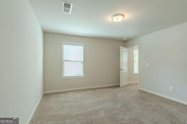 392 Dublin Way, Dallas, GA 30132 - spare room featuring visible vents, baseboards, carpet, and a healthy amount of sunlight