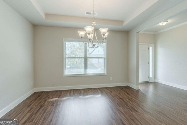 392 Dublin Way, Dallas, GA 30132 - empty room featuring dark wood-style floors, an inviting chandelier, a tray ceiling, visible vents, and baseboards