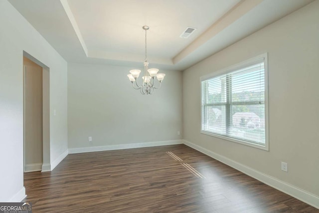 392 Dublin Way, Dallas, GA 30132 - unfurnished room featuring visible vents, a tray ceiling, baseboards, dark wood-style flooring, and a notable chandelier