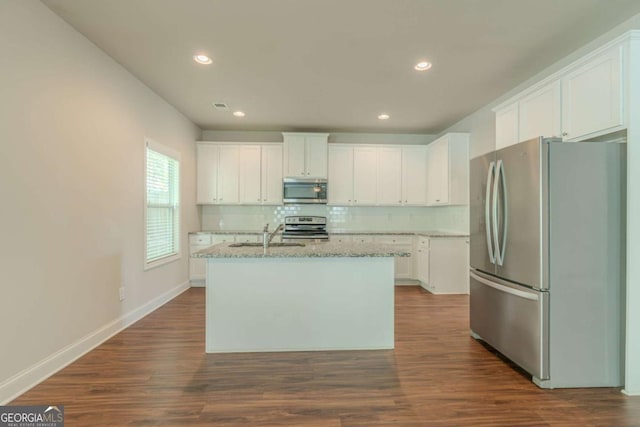 392 Dublin Way, Dallas, GA 30132 - kitchen with light stone counters, stainless steel appliances, white cabinets, and backsplash