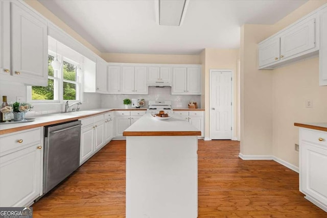 kitchen featuring a sink, under cabinet range hood, white range with gas stovetop, dishwasher, and white cabinets