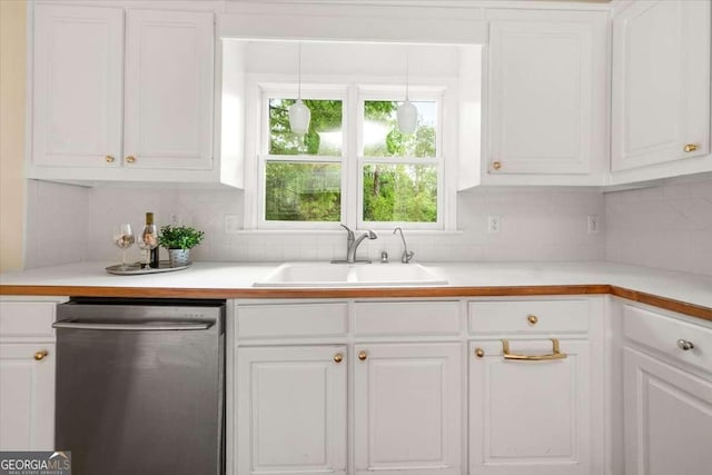 kitchen featuring backsplash, white cabinetry, dishwasher, and a sink