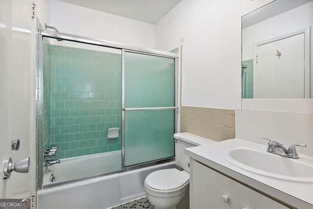 4266 Roswell Rd NE Unit H4, Atlanta, GA 30342 - full bath featuring combined bath / shower with glass door, a wainscoted wall, toilet, tile walls, and vanity