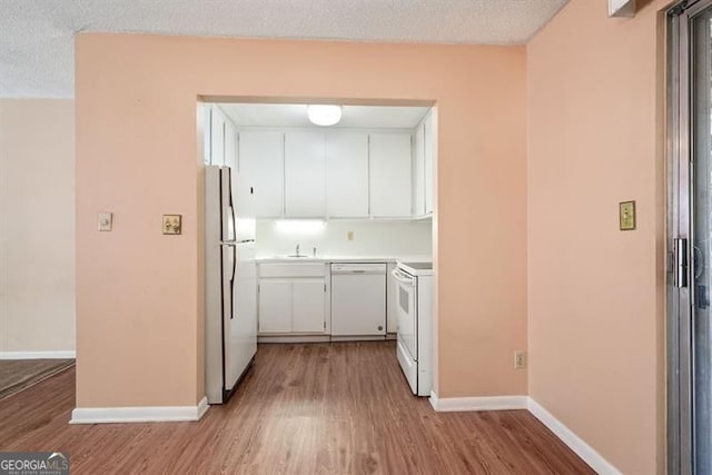 4266 Roswell Rd NE Unit H4, Atlanta, GA 30342 - kitchen featuring white cabinets, wood finished floors, and white appliances