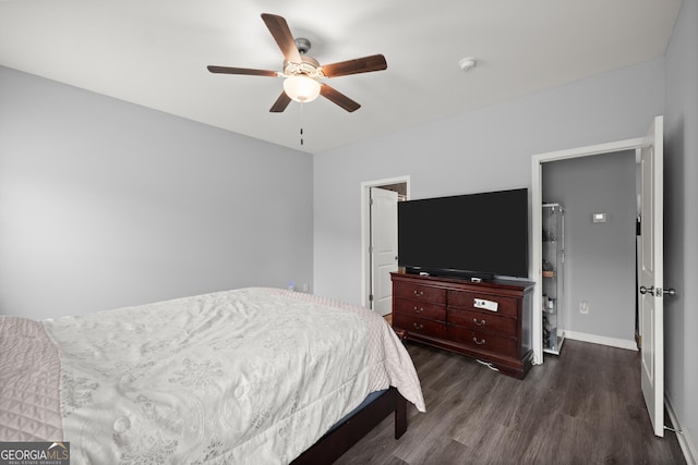 bedroom with a ceiling fan, wood finished floors, and baseboards