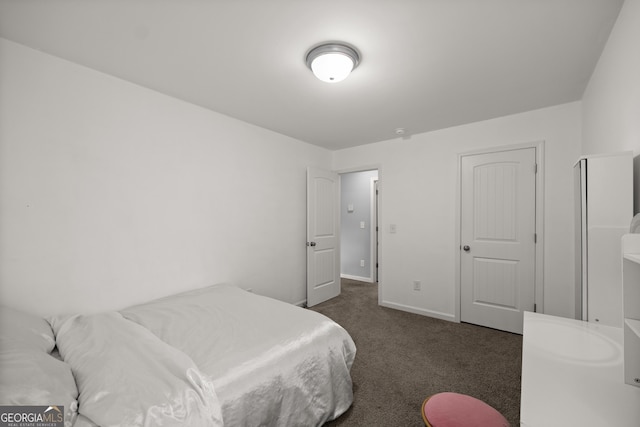 bedroom with carpet flooring and baseboards