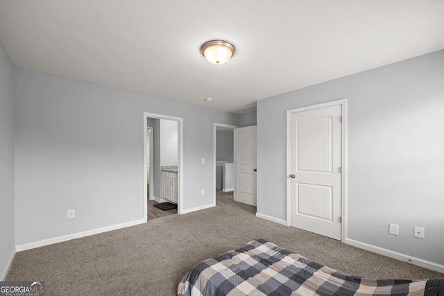 bedroom featuring baseboards, connected bathroom, and carpet
