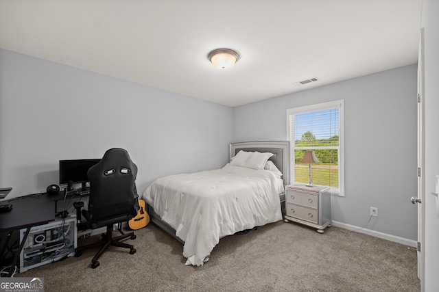 carpeted bedroom featuring visible vents and baseboards