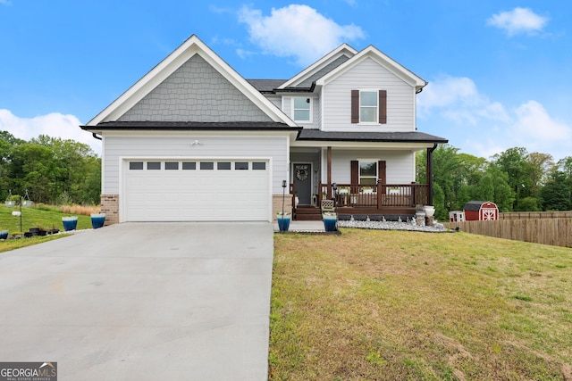 craftsman-style home with covered porch, a garage, a front lawn, and concrete driveway