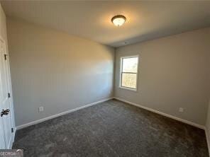 3421 Andover Way, Buford, GA 30519 - empty room with baseboards and dark colored carpet