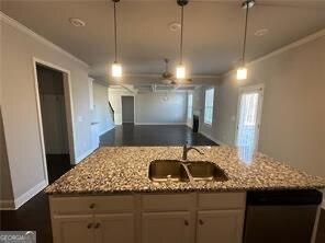 3421 Andover Way, Buford, GA 30519 - kitchen featuring light stone countertops, a sink, open floor plan, stainless steel dishwasher, and ornamental molding