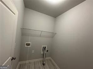 3421 Andover Way, Buford, GA 30519 - laundry area featuring baseboards, laundry area, washer hookup, and wood finished floors