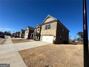 3421 Andover Way, Buford, GA 30519 - view of side of home featuring concrete driveway, a residential view, and a garage