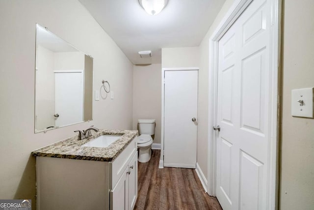 4442 Mercer Rd, Decatur, GA 30035 - bathroom with toilet, wood finished floors, vanity, and baseboards