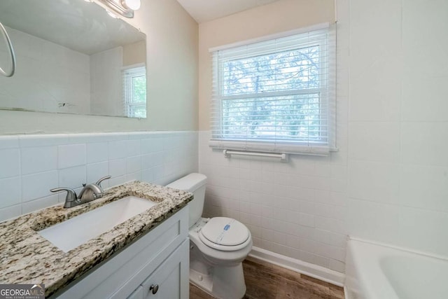 4442 Mercer Rd, Decatur, GA 30035 - bathroom with tile walls, wood finished floors, a healthy amount of sunlight, and toilet