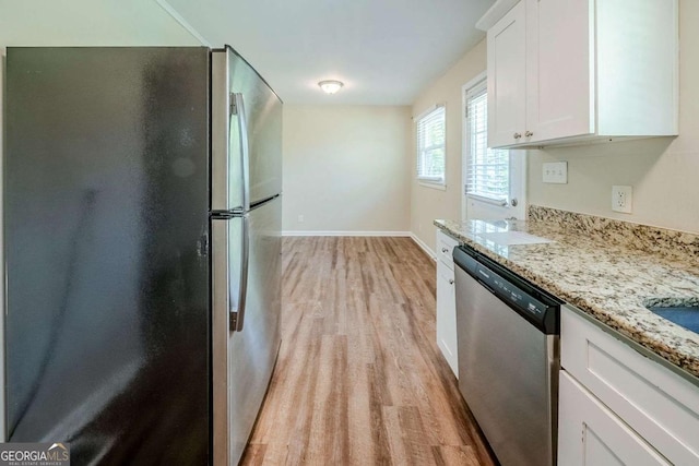 4442 Mercer Rd, Decatur, GA 30035 - kitchen with baseboards, light stone countertops, appliances with stainless steel finishes, light wood finished floors, and white cabinetry