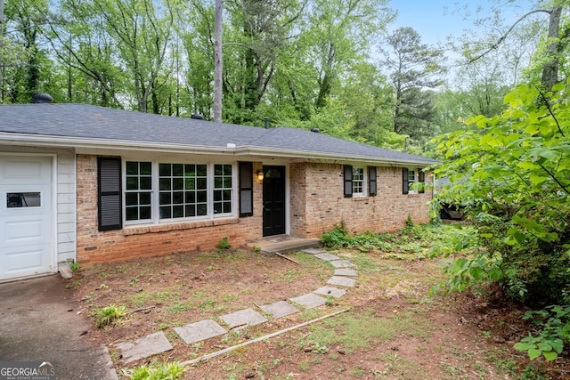 ranch-style home with an attached garage and brick siding