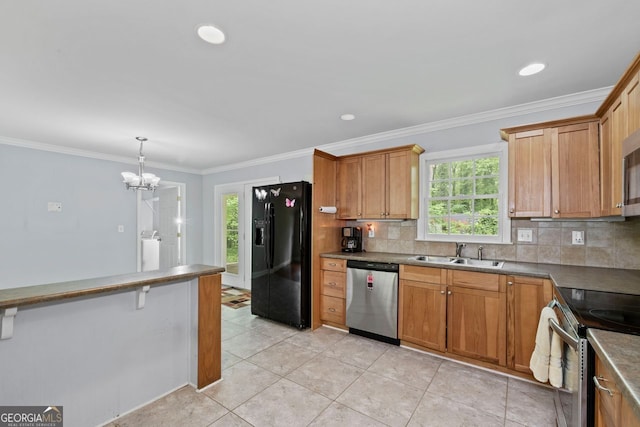 kitchen with backsplash, appliances with stainless steel finishes, plenty of natural light, and a sink