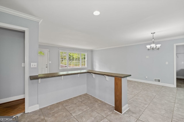 kitchen featuring crown molding, dark countertops, a notable chandelier, visible vents, and pendant lighting