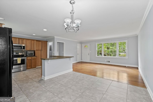 kitchen featuring crown molding, brown cabinets, an inviting chandelier, stainless steel appliances, and light tile patterned floors